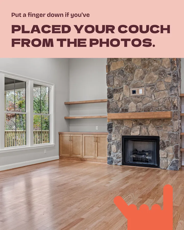 Put a finger down if you've placed your couch from the photos. An empty living room with a stone fireplace, built-in shelves and wood floors. The red hand now has three fingers down.